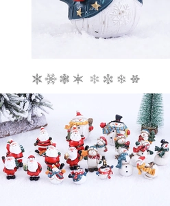 Detail of assorted Christmas resin miniatures featuring Santa and snowmen on snow