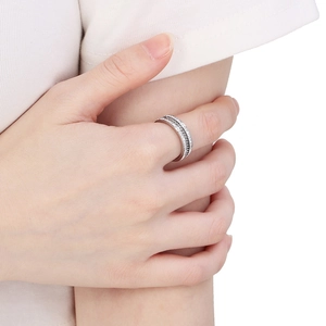 Close-up of a fashion silver multi-layer ring with sparkling zircon inlays on a model hand