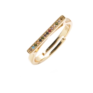 Close-up of golden adjustable ring featuring a colorful baguette-cut rainbow gemstone bar