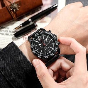 Men's business casual quartz watch with black mesh band and luminous dial on a desk