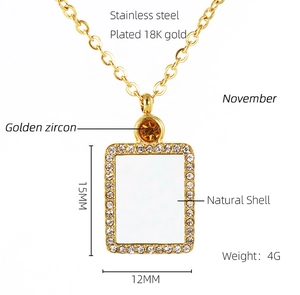 Detail view of 18K gold plated stainless steel November birthstone pendant with shell inlay