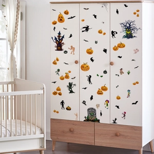 Close-up of Halloween wall stickers with pumpkins and bats on a white nursery wardrobe