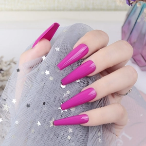 Detail of glossy hot pink extra-long ballerina press-on nails with UV top coat