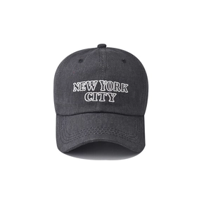 Detail of white New York City embroidery on dark gray washed cotton baseball cap
