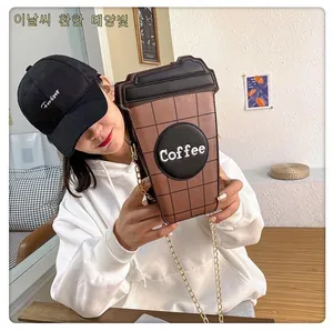 Detail of coffee cup shaped crossbody bag with gold chain and coffee embroidery
