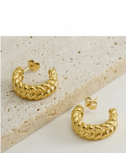 Detailed macro view of 18k gold plated stainless steel C-shape twisted rope earrings