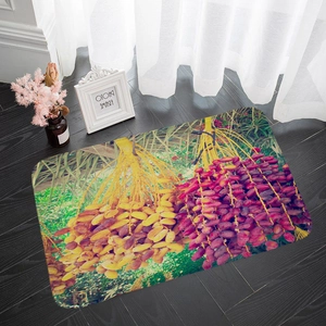 Detailed close-up of a fruit printed flannel floor mat on dark wood flooring