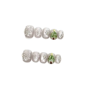 Sparkly Christmas snowflake press-on nails with silver cat-eye base and green tree art