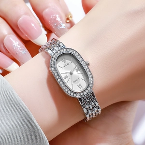 Women's oval silver quartz watch with diamond bezel and stainless steel strap on wrist