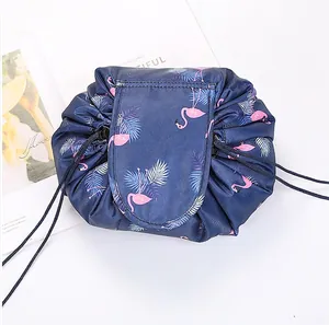 Detail of drawstring makeup bag with flamingo print and secure flap closure design
