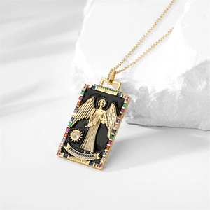 Macro shot of gold Temperance tarot card pendant with colored stones and angel relief