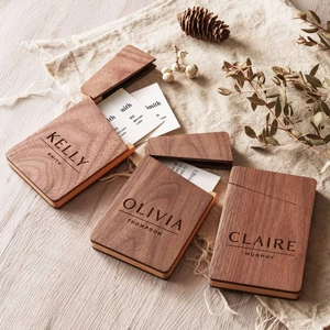 Custom engraved black walnut wood business card holder on rustic linen background