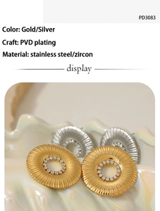 Detail of PVD plated stainless steel sunflower earrings with zircon inlays and gold finish