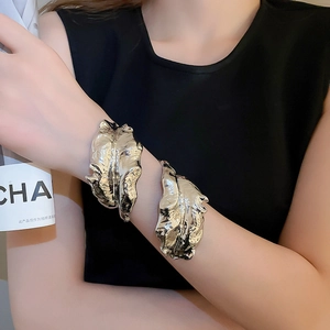 Detailed macro shot of textured liquid metal leaf arm cuff with a silver wrinkled finish