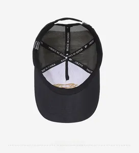 Detail view of the breathable mesh back and cotton inner lining of the black trucker hat