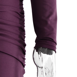Detail of elegant dark purple evening dress featuring side pleats and ruched fabric texture