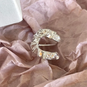 Detailed view of 925 sterling silver ring with organic wrinkled texture and lava pattern
