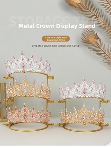 Close-up of golden metal crown display stands with sparkling rhinestone hair accessories