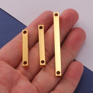 Three gold stainless steel 3D rectangular bar pendants with double holes shown on hand