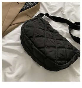 Detailed close-up of a black quilted puffer bag with elegant diamond stitching