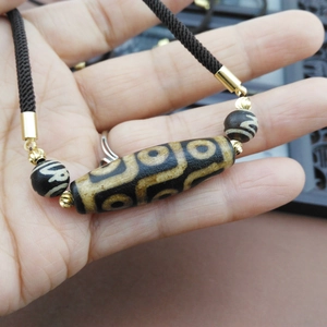 Handcrafted necklace cord with dZi bead pendant and golden spacer beads decoration
