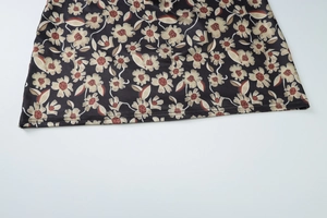 Detail view of floral print skirt hem showing high-quality double-needle stitching and fabric