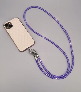 Detail of purple rhinestone braided phone strap with silver clasp on a stylish phone case
