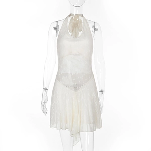 Detail of white lace halter dress showing intricate floral crochet and backless cut