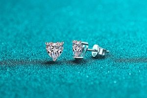 Macro shot of S925 sterling silver heart-shaped moissanite stud earring with hallmarks