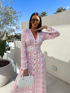 Detail of V-neck floral maxi dress featuring pink blossom patterns and button-down front