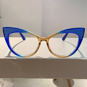 Close-up of cat-eye glasses frame with blue glitter accents and amber gradient finish