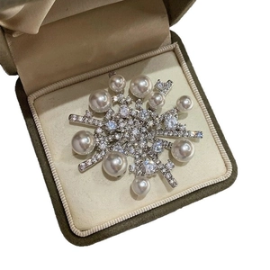 Exquisite snowflake brooch with white pearls and zircons in an olive green jewelry box