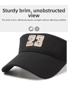 Detail of black sun visor hat featuring textured fabric and embroidered number 23