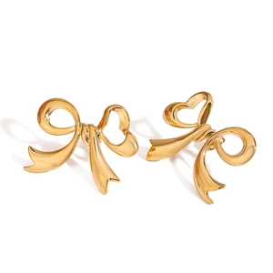Polished gold bow earrings in stainless steel with hollow heart design on white background