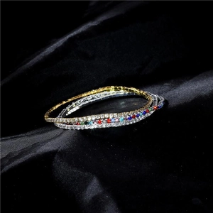 Close-up of 2.0mm single row elastic rhinestone bracelets in gold, silver, and multicolor