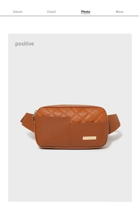 Front view of brown quilted waist bag with golden metal plate and woven shoulder strap