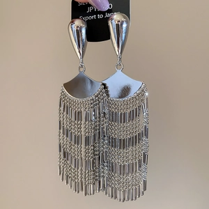 Detailed macro view of S925 silver fringe earrings with fan shaped metal tassels