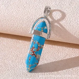 Close-up of hexagonal blue turquoise stone pendant with silver metal clasp detail