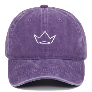 Close-up of crown embroidery and distressed purple washed cotton texture on baseball cap