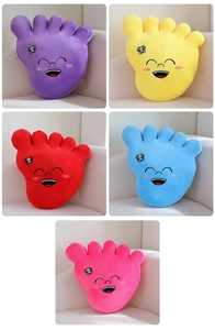 Close-up of soft big foot plush pillows with cartoon faces and spider patterns in five colors