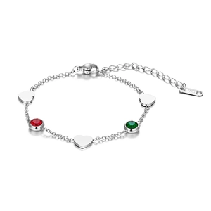 Detailed shot of stainless steel chain bracelet with heart charms and red green gemstones