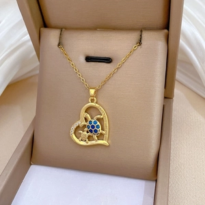 Detail of gold heart pendant with blue turtles and I love you Mom engraving in a gift box