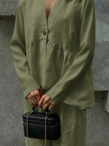 Women's green linen two-piece set featuring V-neck long-sleeve top and matching trousers