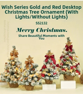 Detail of 60cm tabletop Christmas tree with gold stars, red bows, and warm LED lights