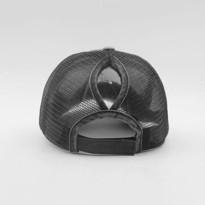 Detail of the back ponytail hole and adjustable strap on the black mesh trucker cap