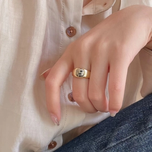 Detailed view of wide gold sterling silver ring featuring a spotted zebra stone inlay