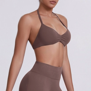 Detail view of seamless dark brown halter yoga bra and high waist leggings on a model