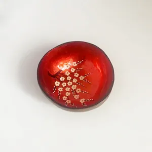 Handcrafted coconut shell bowl with bright red lacquer and white plum blossom patterns