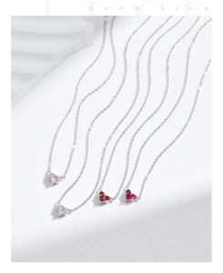 Detail of four S925 sterling silver necklaces with heart-shaped colorful birthstones