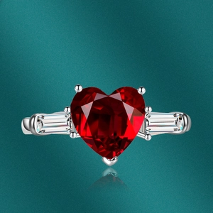 Macro detail of luxury heart-shaped pink zircon ring with side trapezoid diamonds
